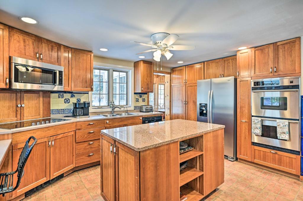 a kitchen with wooden cabinets and a stainless steel refrigerator at All Year-Round Retreat Near Windham Mountain 