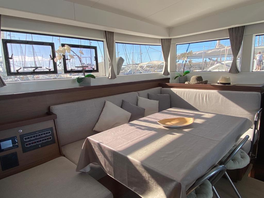 a dining room with a table and some windows at Catamaran White Beach in Playa Blanca