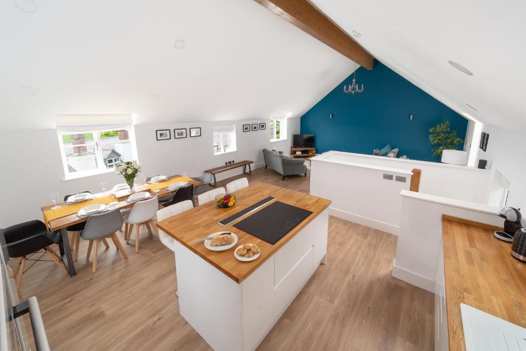 a kitchen and living room with a table and chairs at Goodleigh Cottage in Goodleigh