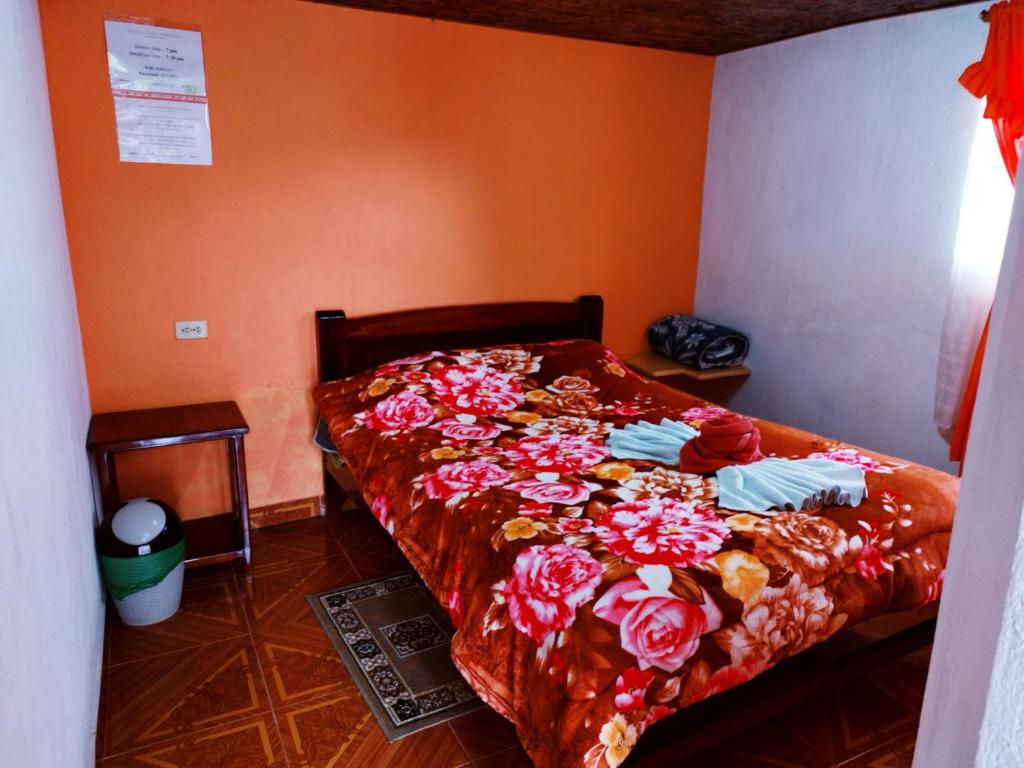Postel nebo postele na pokoji v ubytování Hostal Taita Cristobal