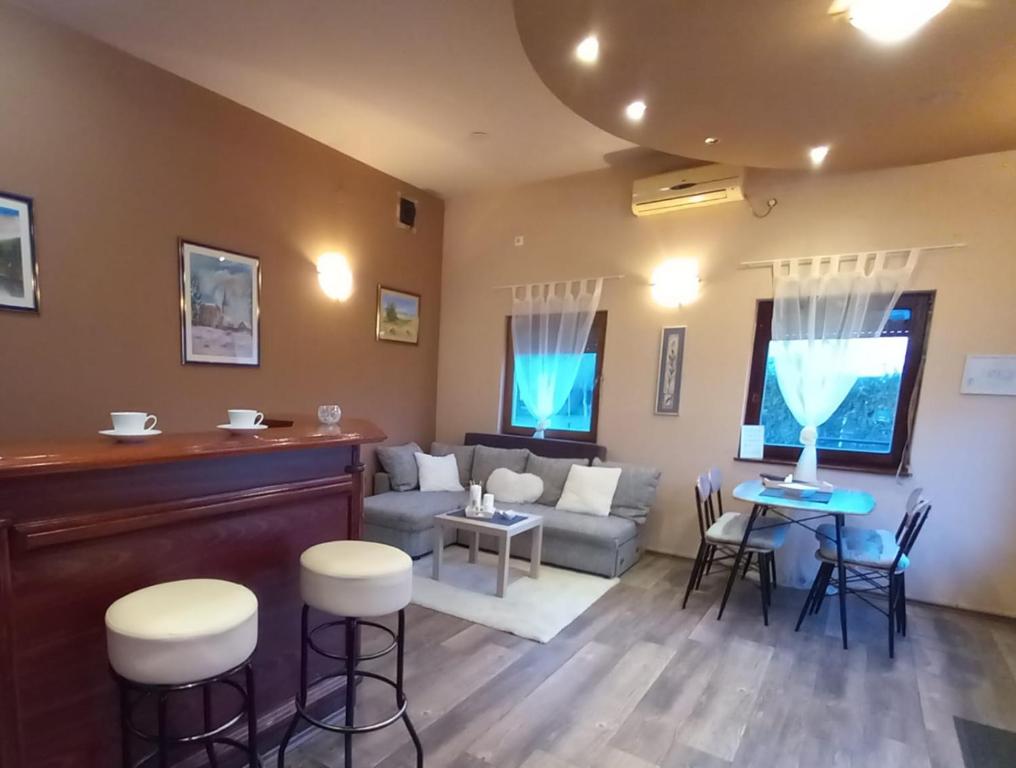 a living room with a couch and a table and chairs at Guest house - studio apartman Marina in Karlovac