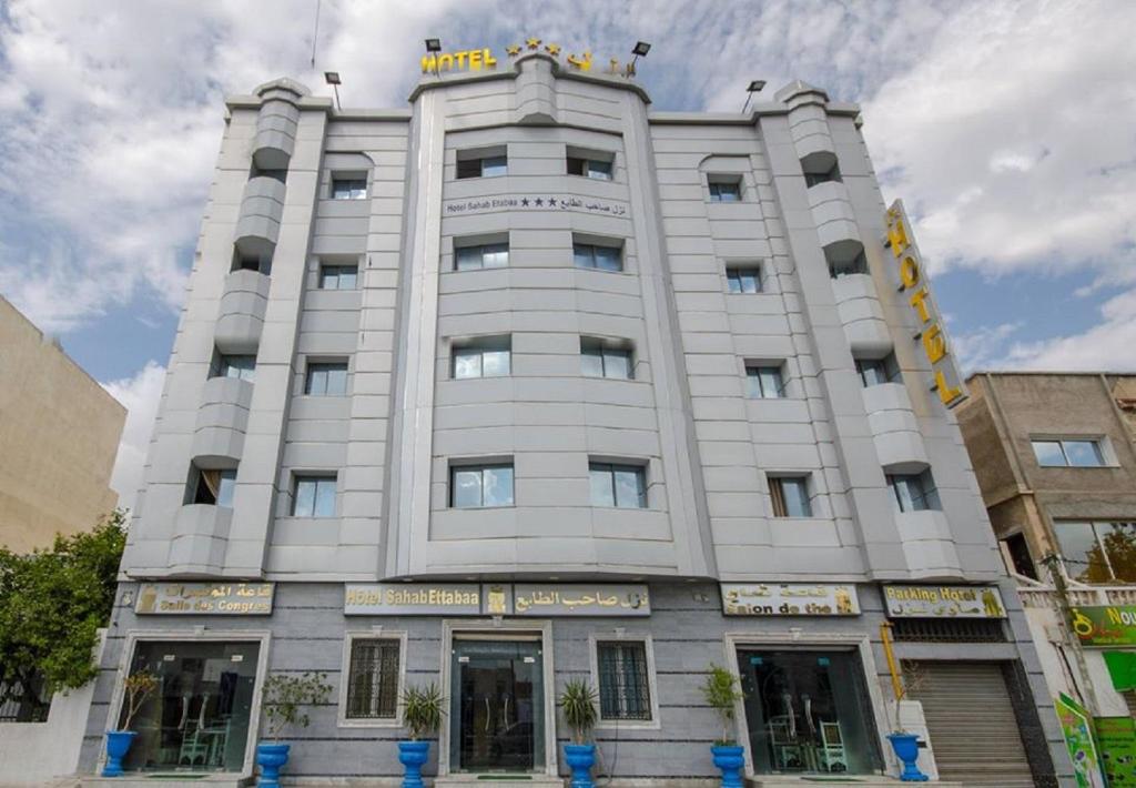 a white building with a sign on top of it at Saheb Ettabaa Tunis in Tunis