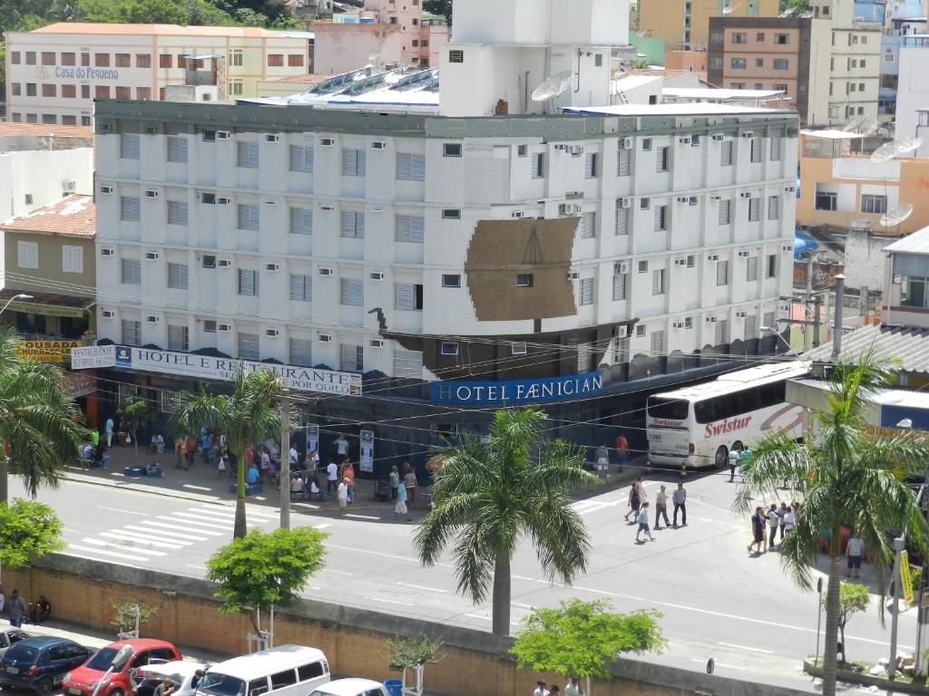 a building with a sign on it in a city at Hotel Faenician in Aparecida