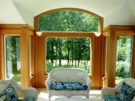 ein Wohnzimmer mit 2 Stühlen und 2 Fenstern in der Unterkunft Light Of The Valley River House in Woodstock