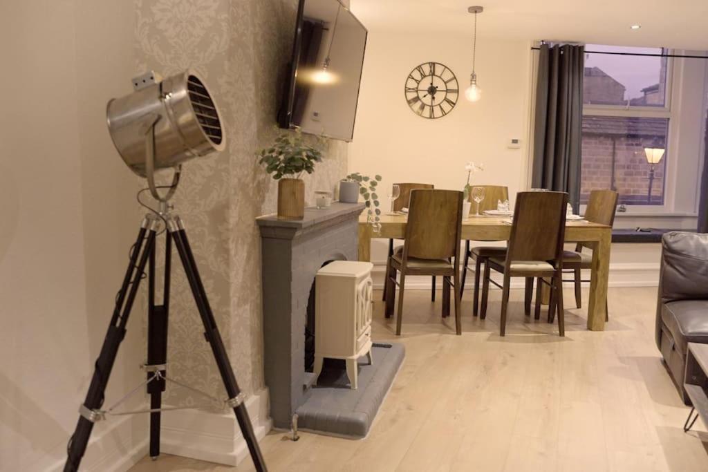 a camera on a tripod in a living room with a table at Apartment in West Yorkshire 59 in Keighley
