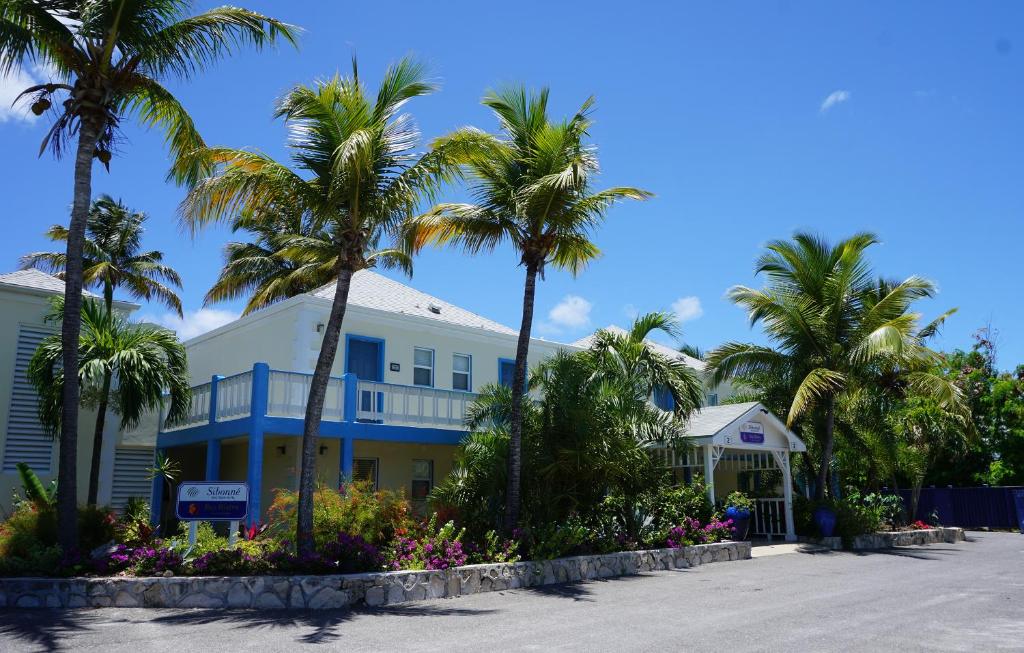 un bâtiment avec des palmiers en face de celui-ci dans l'établissement Sibonne Beach Hotel, à Grace Bay