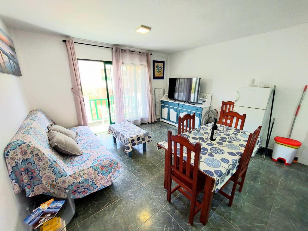 sala de estar con mesa, sofá y cocina en Casa Azul, en Costa de Antigua