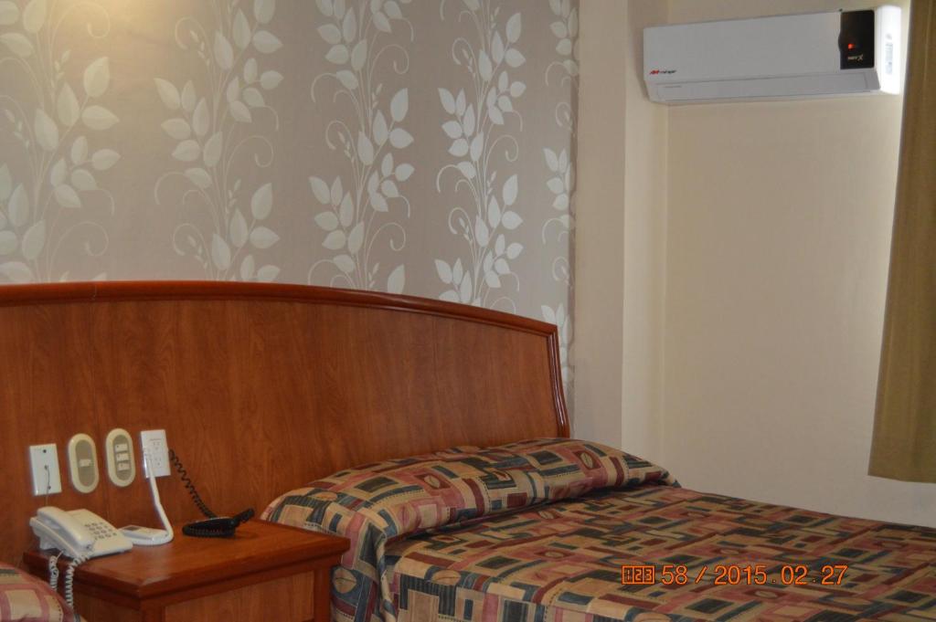 Postel nebo postele na pokoji v ubytování Hotel Impala Veracruz