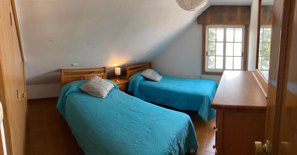 Postel nebo postele na pokoji v ubytování Apartamentos Gamela en Playa Canido - Vigo