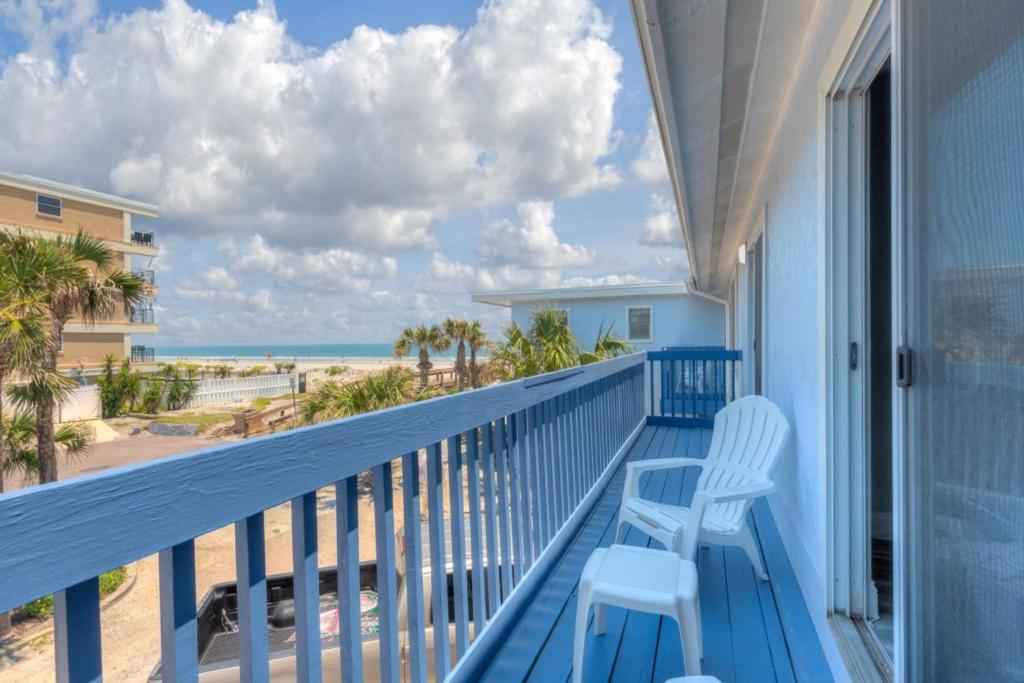 a balcony with a blue railing with a view of the beach at Once Upon A Tide Oceanview Condo Pet Friendly in Jacksonville Beach
