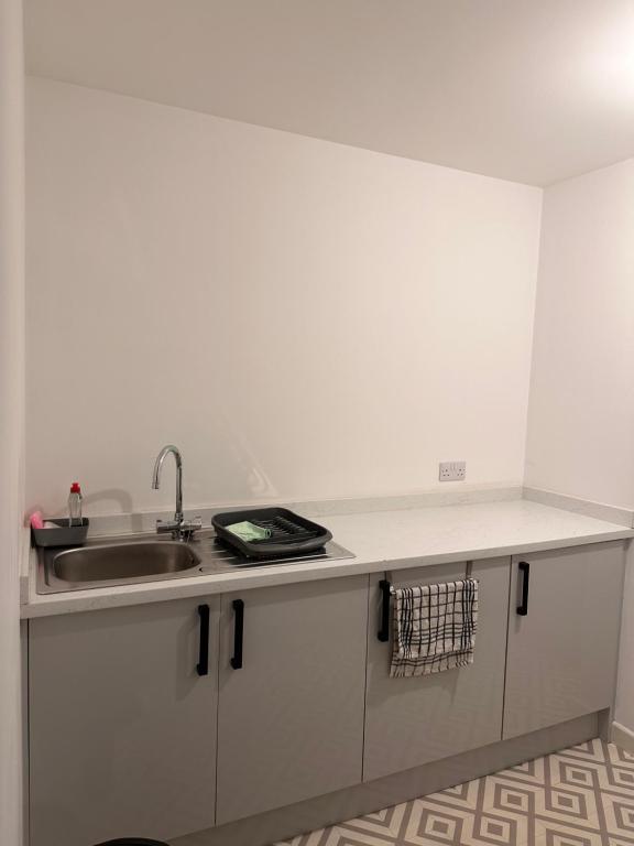 a kitchen with a sink and a counter top at City Blessed Apartment 1 with free parking in North Shields