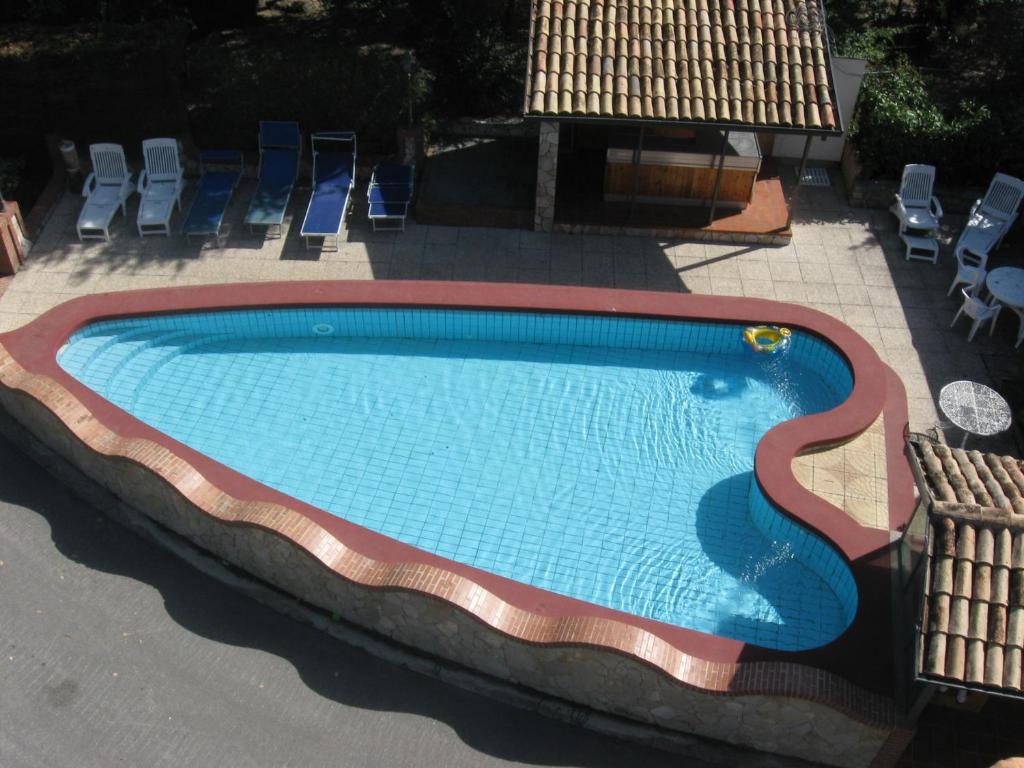 a large swimming pool with chairs around it at Parco Sogni d'Oro in Montella