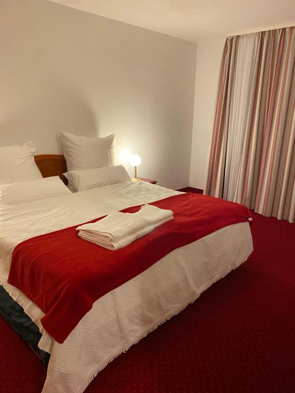 a hotel room with a bed with two towels on it at Kaiserburg Apartment in Nuremberg