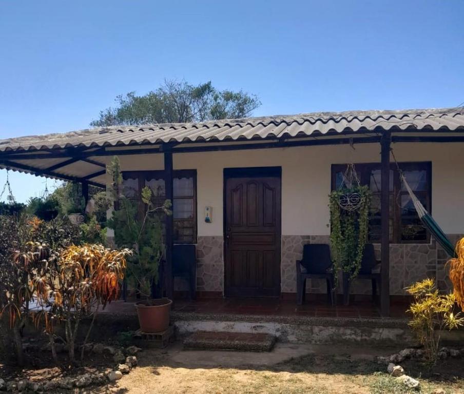 a house with a wooden door and a patio at Jilymar Cabaña de descanso, Isla de Barú - Cartagena in Santa Ana