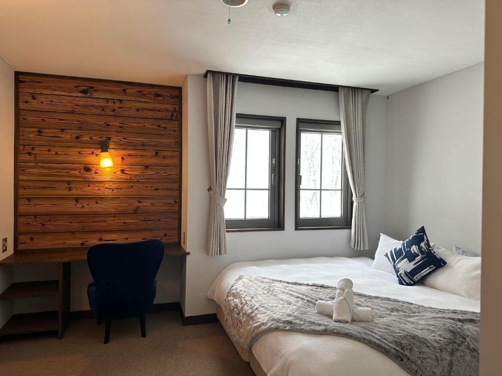 Postel nebo postele na pokoji v ubytování Legend Inn Myoko