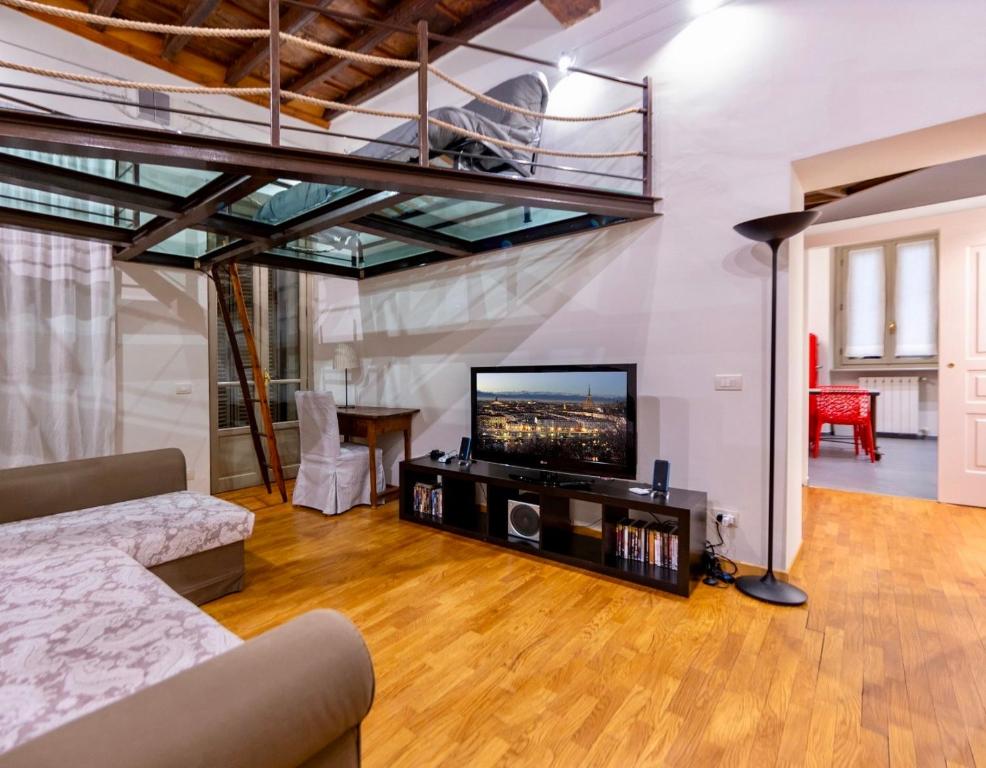 a living room with a couch and a flat screen tv at Cuore della città by Home a porter in Turin