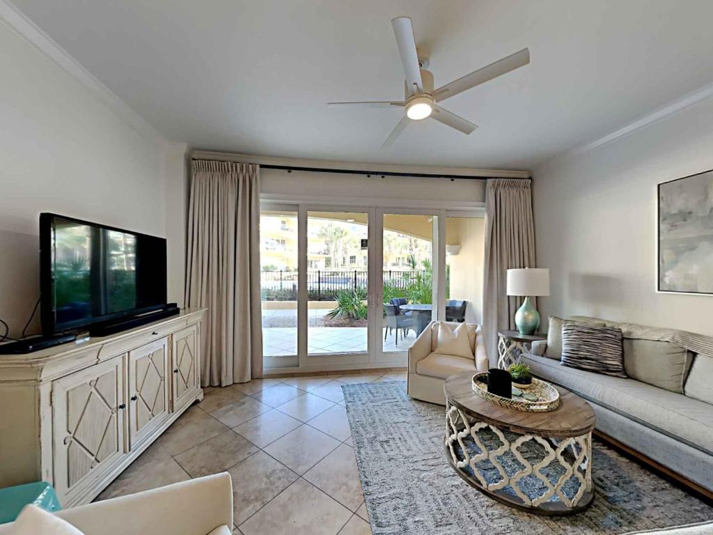 a living room with a couch and a flat screen tv at Adagio 103F in Santa Rosa Beach