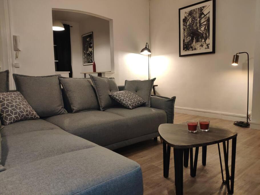 a living room with a couch and a table at Au cœur du Quartier St Vincent de Paul, Le Havre in Le Havre