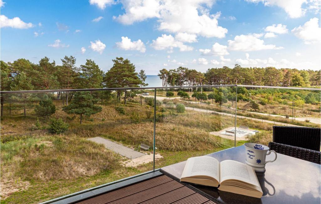 a cup of coffee and books on a balcony with a view at Cloud in Binz