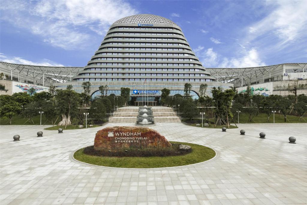 a large building with a fountain in front of it at Wyndham Chongqing Yuelai in Chongqing