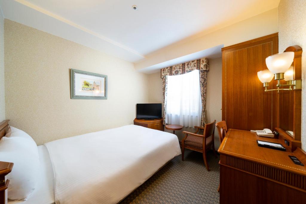 Postel nebo postele na pokoji v ubytování KOKO HOTEL Nagoya Sakae