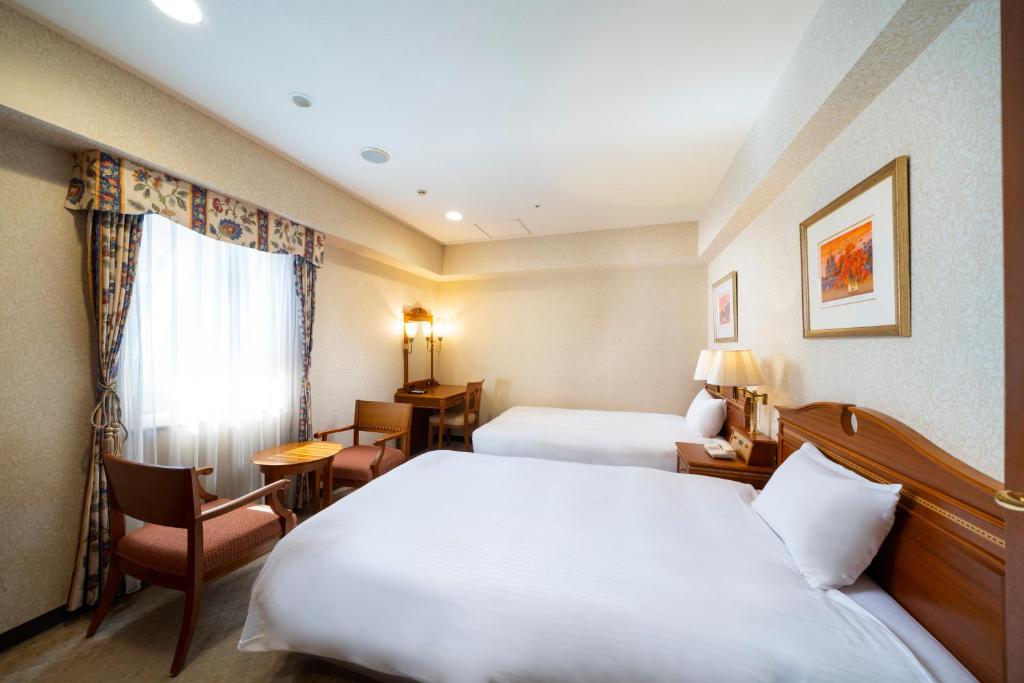 Postel nebo postele na pokoji v ubytování KOKO HOTEL Nagoya Sakae