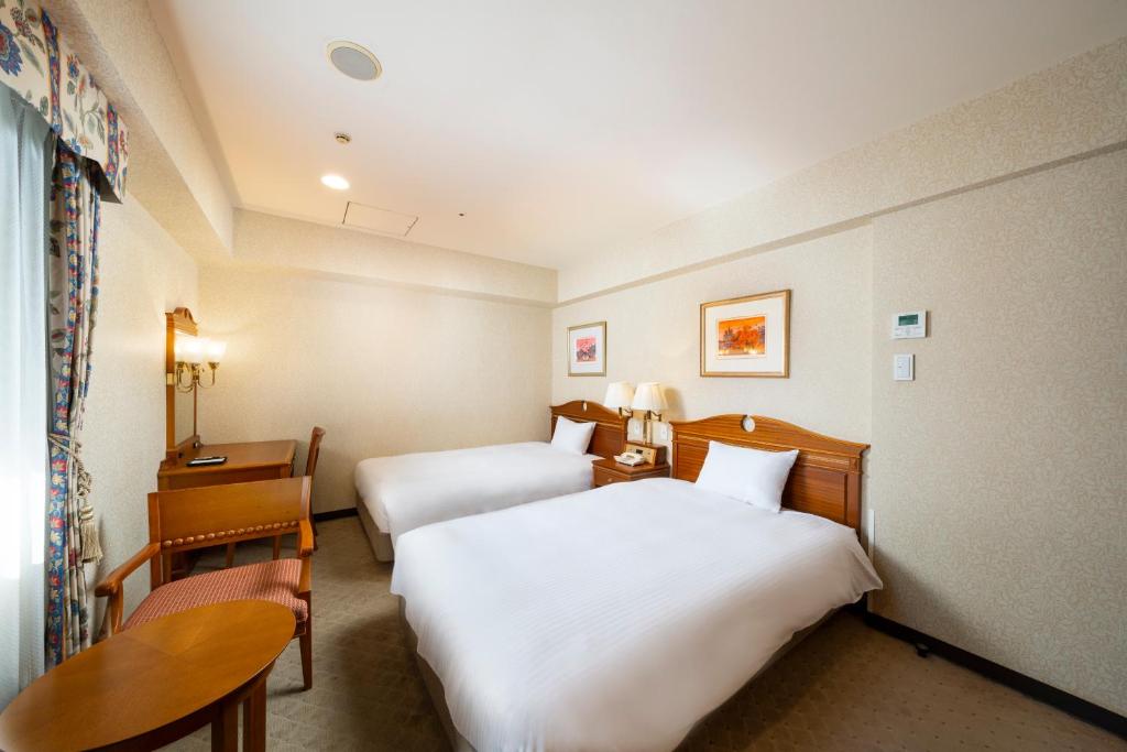 Postel nebo postele na pokoji v ubytování KOKO HOTEL Nagoya Sakae