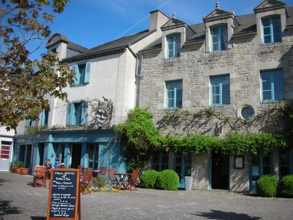 a large stone building with a sign in front of it at Auberge Bretonne in La Roche-Bernard