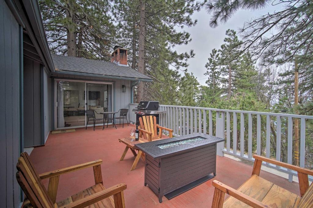 a deck with chairs and a grill on a house at Running Springs Home with Skiing Less Than 6 Mi Away! in Running Springs
