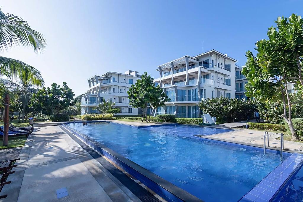 a large swimming pool in front of a building at Beach Paradise Nilaveli in Trincomalee