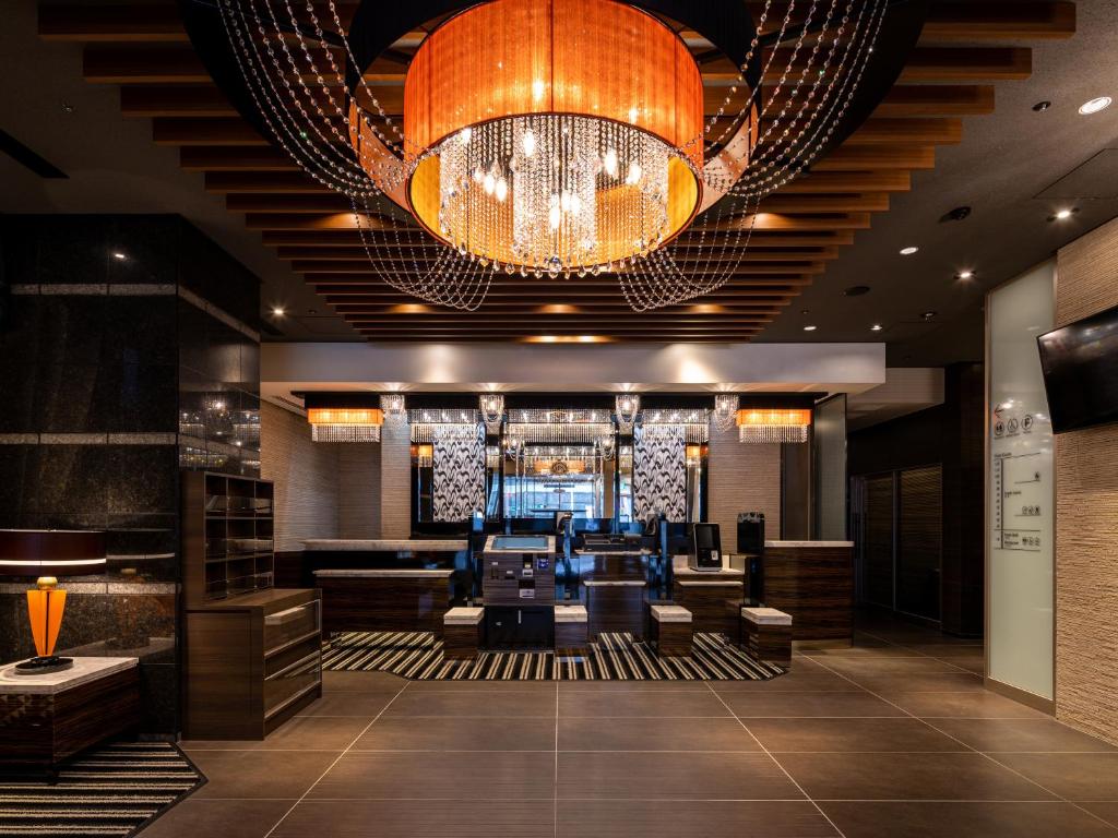 a lobby of a hotel with a chandelier at APA Hotel Nagoya Fushimi Ekikita in Nagoya