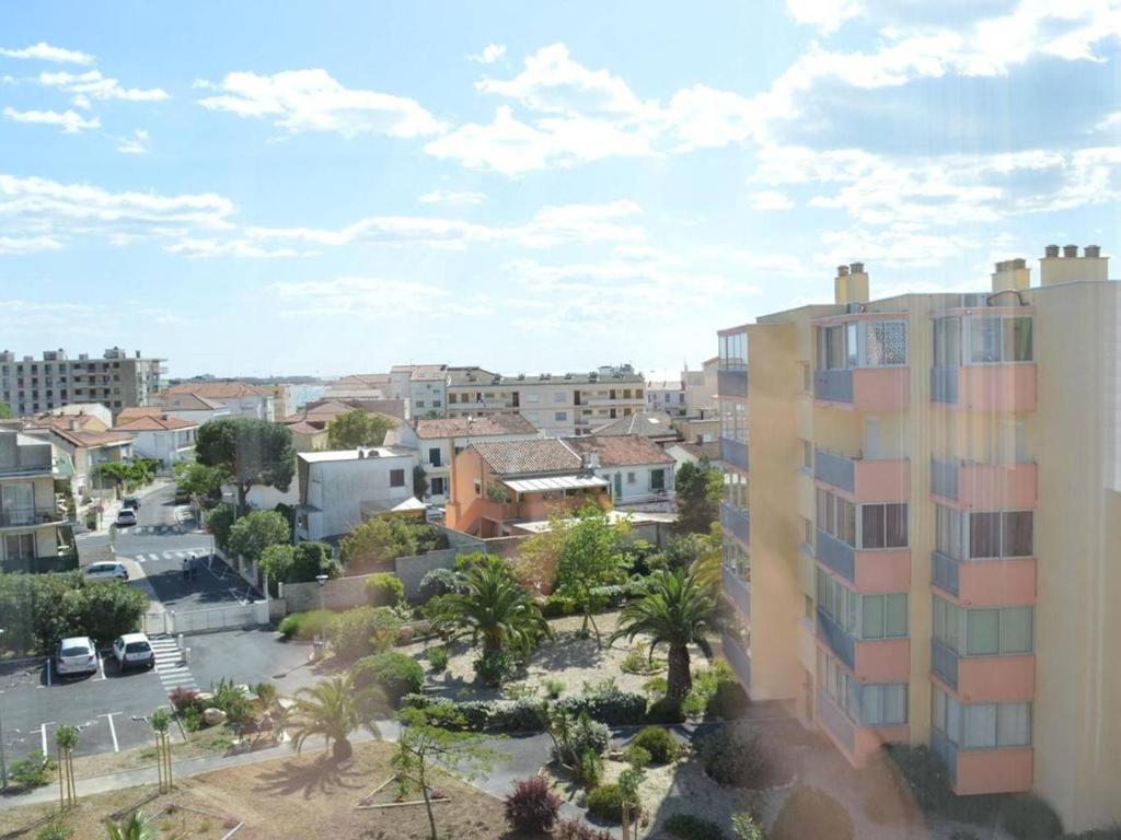 a view of a city with buildings and palm trees at Appartement Le Grau-du-Roi, 3 pièces, 6 personnes - FR-1-250-61 in Le Grau-du-Roi