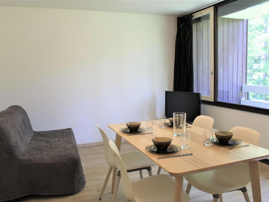 une salle à manger avec une table, des chaises et une télévision dans l'établissement Appartement rénové à 20m des pistes, WIFI, parking privé, 4 couchages à Vars - FR-1-330B-23, à Vars