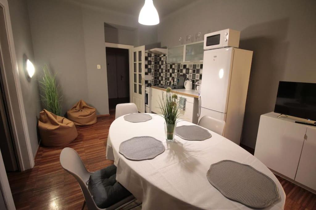 a kitchen with a white table and a white refrigerator at 2 Bedrooms close Vyšehrad - Congress centrum in Prague