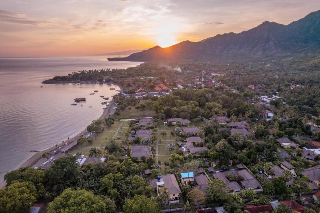 an aerial view of a town next to the water at Amertha Bali Villas in Pemuteran