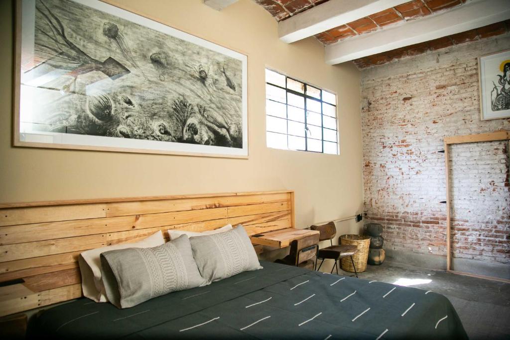 a bedroom with a bed and a painting on the wall at 509 Accommodation in Oaxaca City