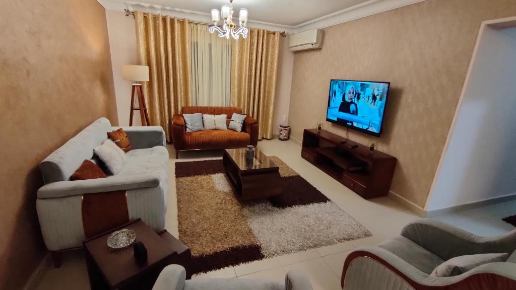 a living room with a couch and a television at شقة انور المفتى للعائلات فقط 113 in Cairo