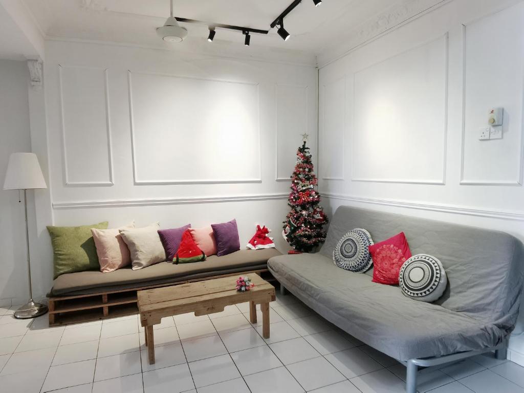 a living room with a couch and a christmas tree at The Secret Place in Melaka
