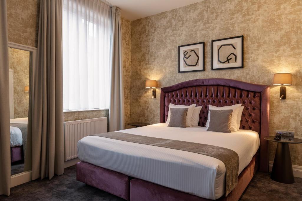 a hotel room with a large bed and a window at Dukes' Academie Brugge - by Dukes' Hotel Collection in Bruges