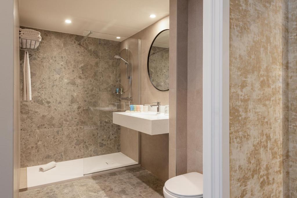 a bathroom with a toilet and a sink at Dukes' Academie Brugge - by Dukes' Hotel Collection in Bruges