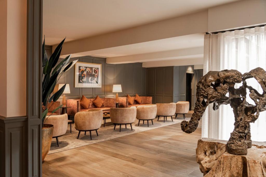 a lobby with a waiting area with chairs and a waiting room at Dukes' Academie Brugge - by Dukes' Hotel Collection in Bruges
