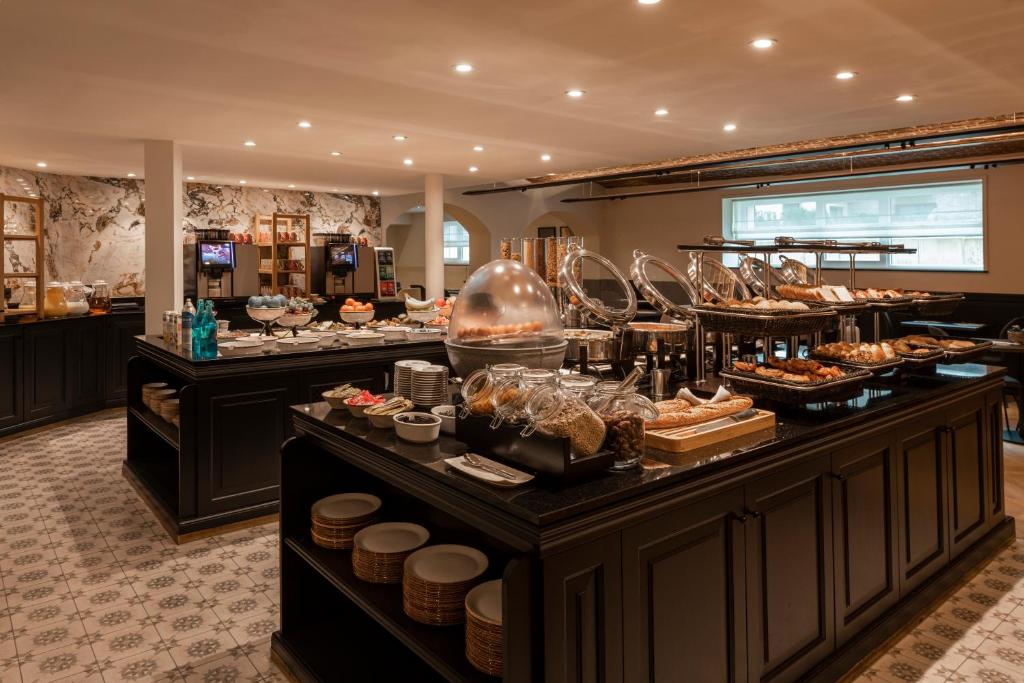 a buffet line with many different types of food at Dukes' Academie Brugge - by Dukes' Hotel Collection in Bruges