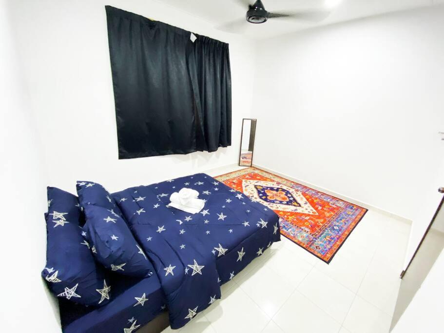 Habitación con cama azul y cortina negra en D'Cahaya Homestay Batu Pahat, en Batu Pahat