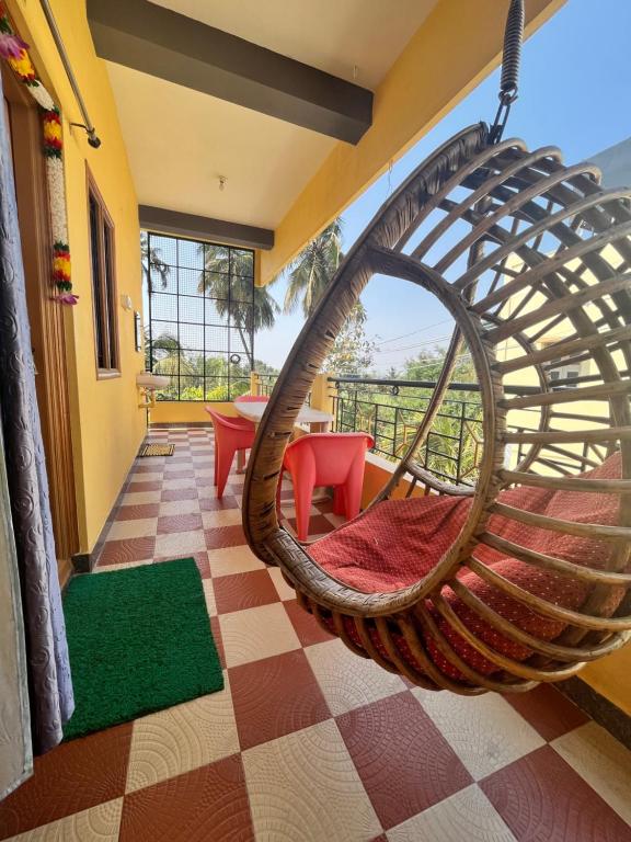 a hanging hammock in a room with a view at VAIBHAV HOME STAY in Hampi