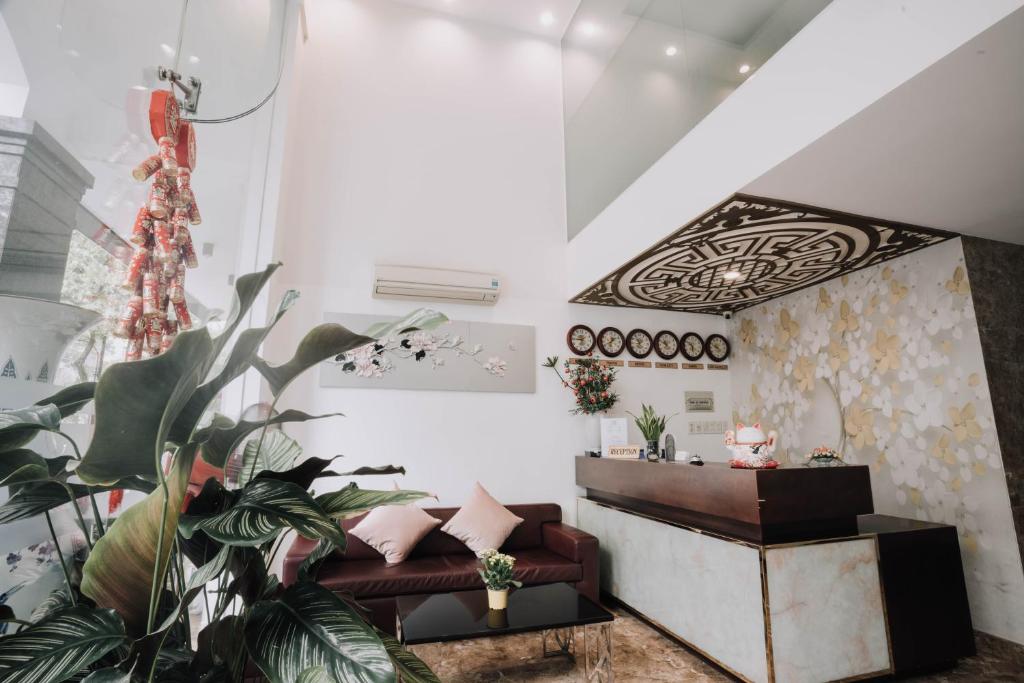 ein Wohnzimmer mit einem Sofa und einem Tisch in der Unterkunft Song Hưng Hotel & Serviced Apartments - Căn hộ Dịch vụ & Khách sạn in Ho-Chi-Minh-Stadt
