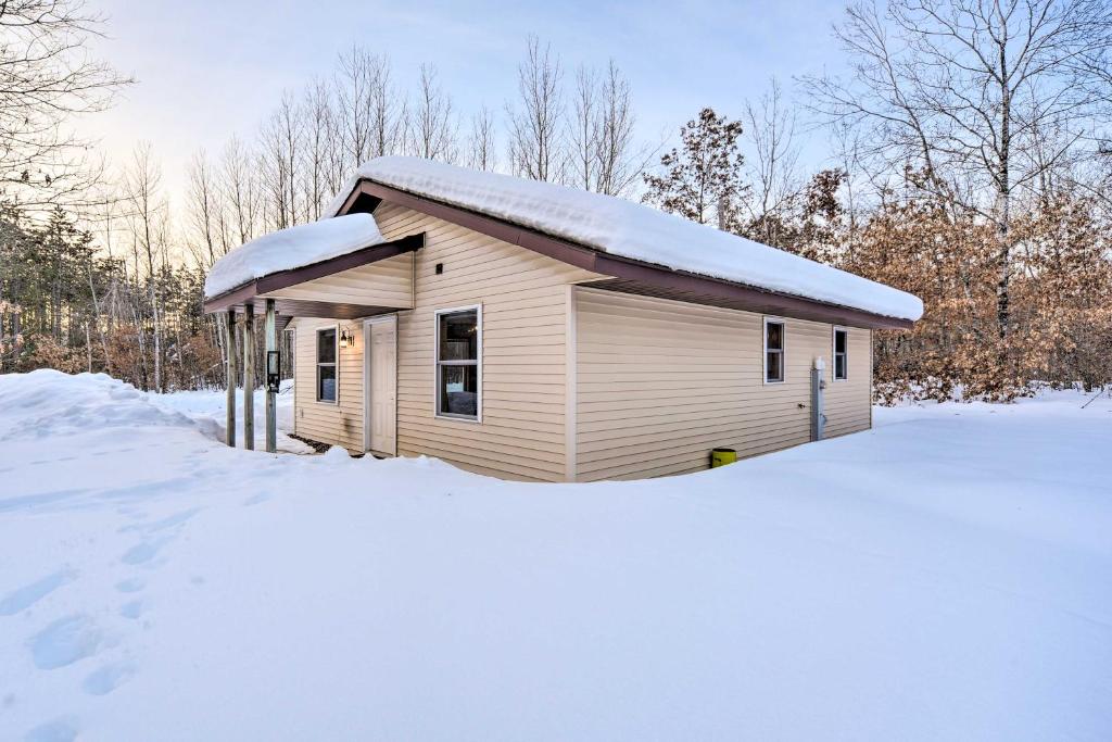 a smallshed with snow on top of a snow covered yard at Wooded Danbury Cabin with Grill and Fire Pit! in Danbury