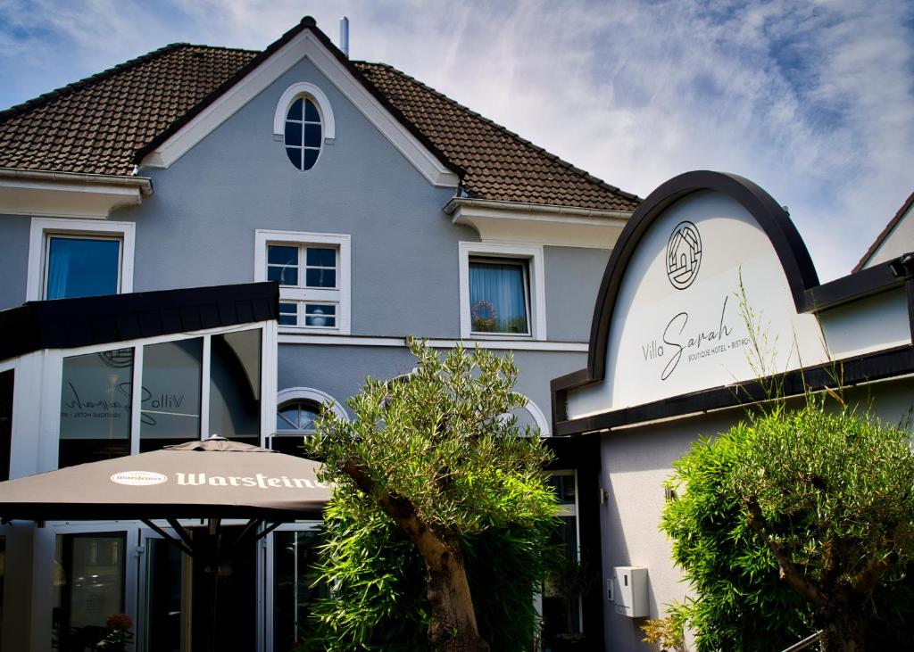 a building with a sign in front of it at Boutique Hotel Villa Sarah in Düsseldorf