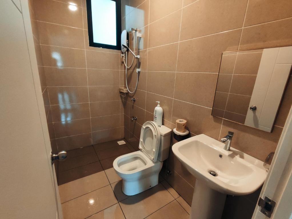 a bathroom with a toilet and a sink at Banana Homestay Kuching - P' Residence in Kuching
