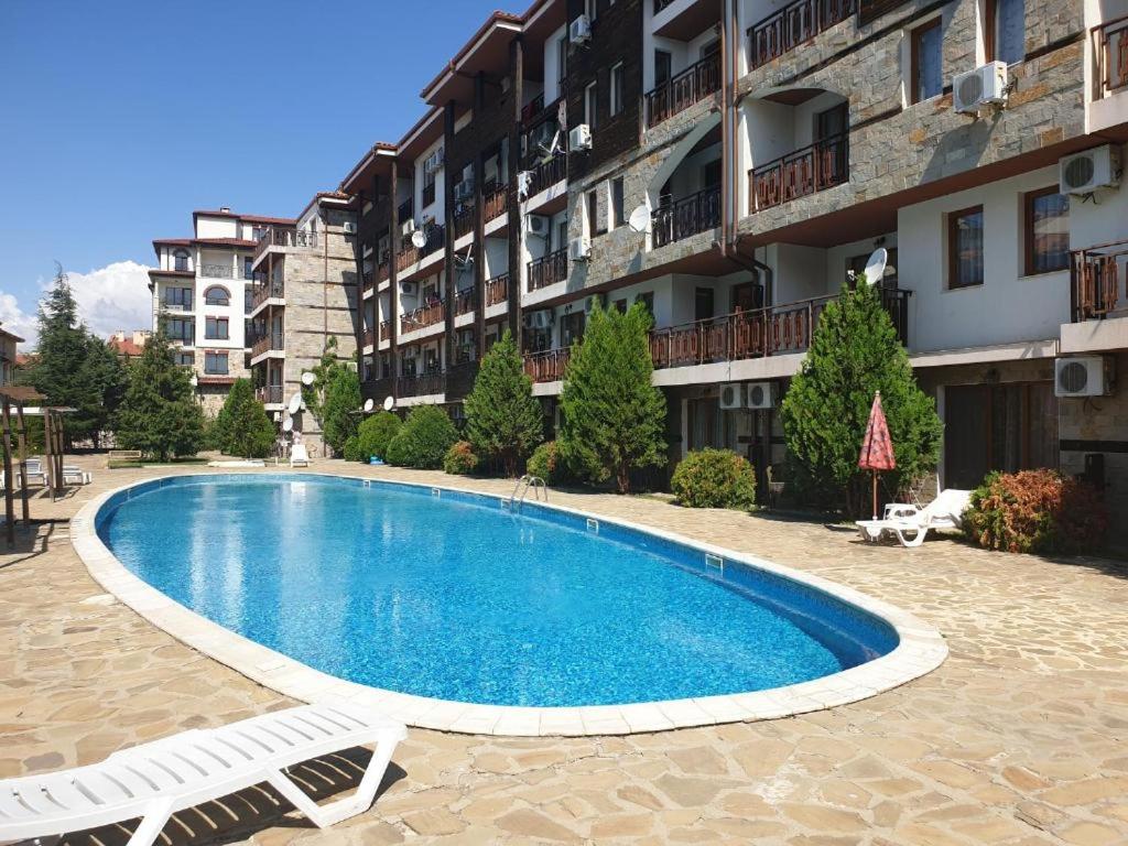a swimming pool in front of a building at MitProt ApartCompleks Panorama Bay 2 in Sveti Vlas