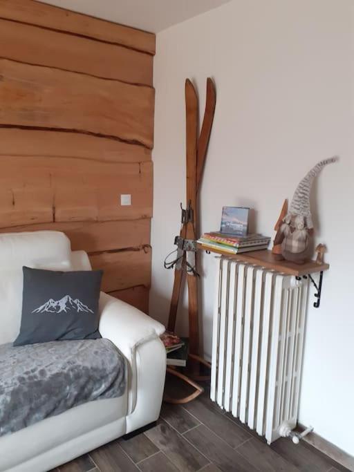 a room with a couch and a table with skis at Gite du Prinas in Gréolières